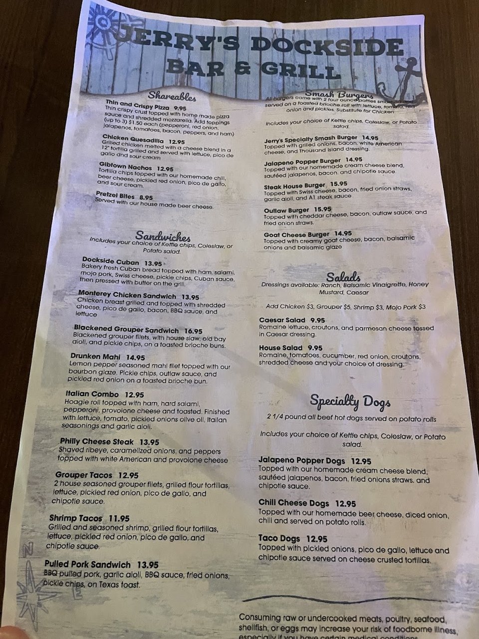 Printed menu with sandwiches and burgers.