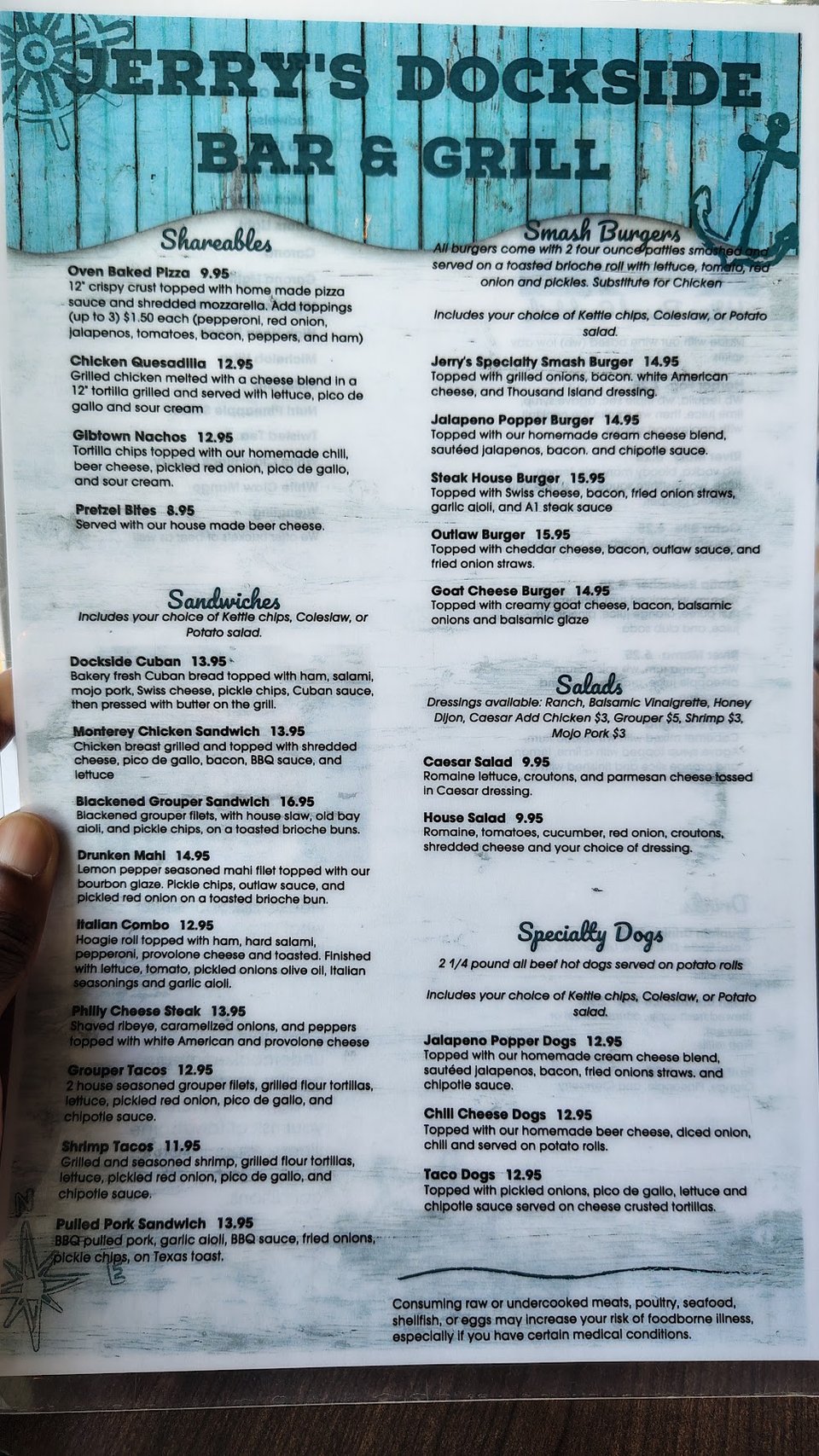Restaurant menu beside a drink glass.